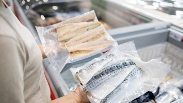 woman buying fish at the supermarket