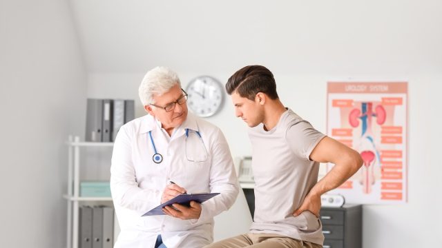 Young man visiting urologist in clinic kidney screening