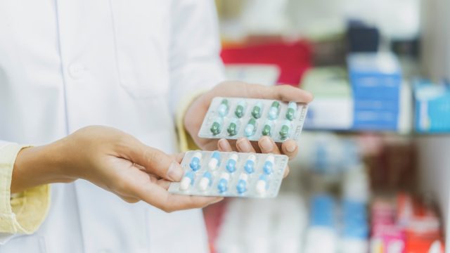 Close up hand of Pharmacist holding medicine