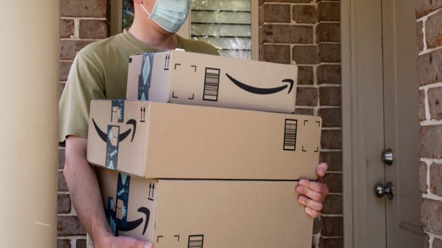 Amazon prime boxes and delivered to a front door of residential building during the COVID-19 pandemic.