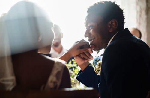 Couple Kissing Hands at wedding