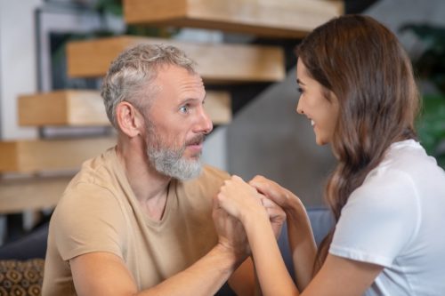 Man and woman talking and holding hands