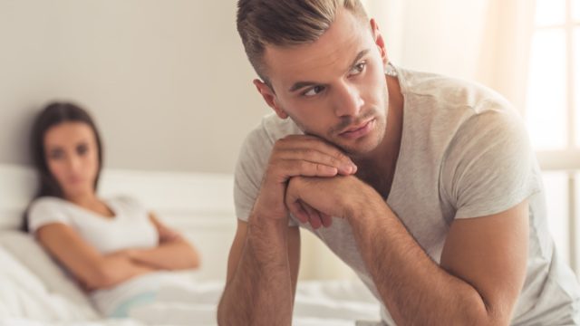 Man looking upset and woman behind him
