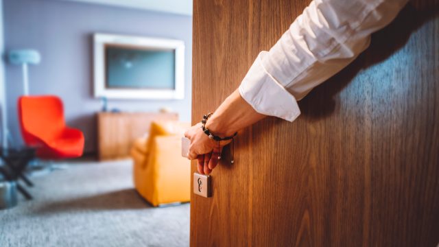 A person entering a hotel room