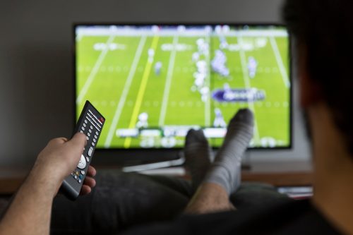 man watching American football on tv