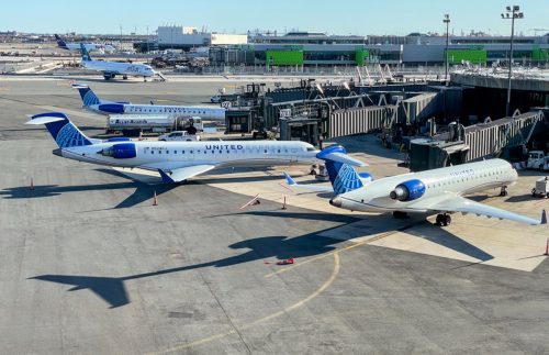 United Express airplanes are parked at the gates of a Newark airport terminal.