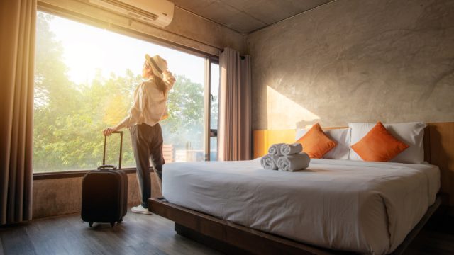 A woman entering her hotel room after check in