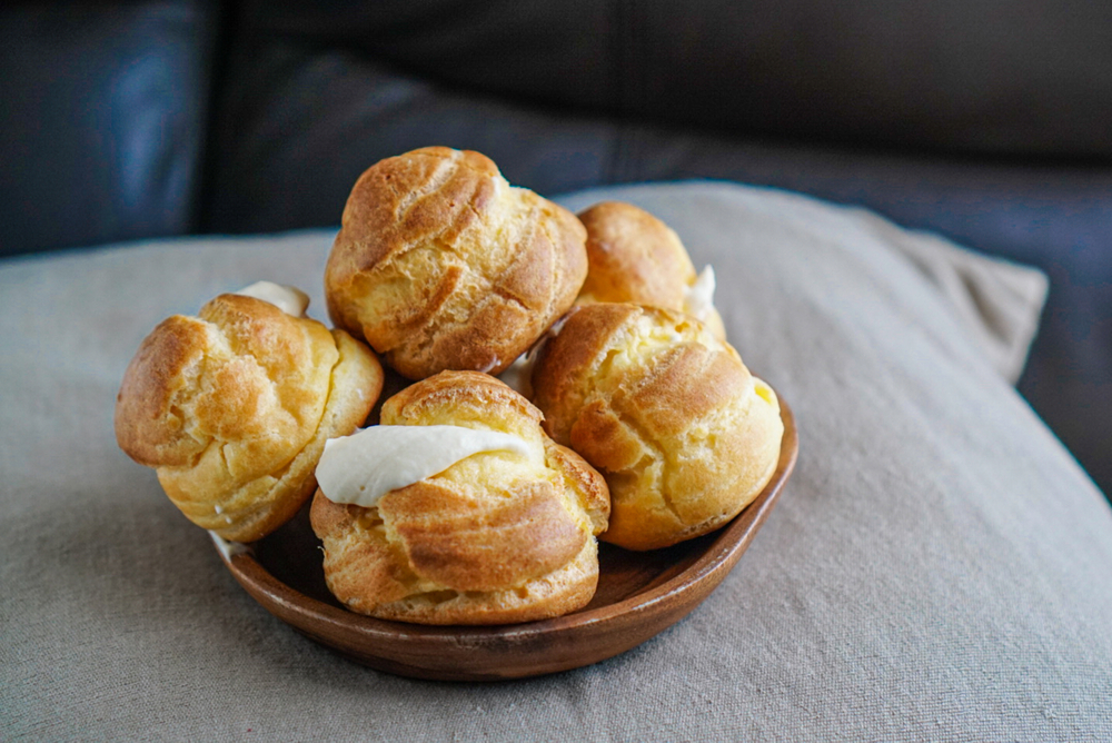 A plate of cream puff desserts