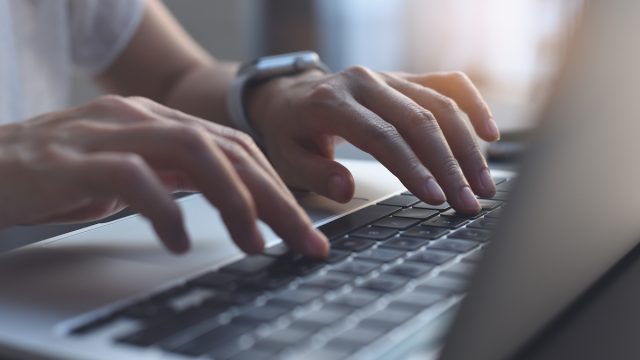Woman Typing on Computer.