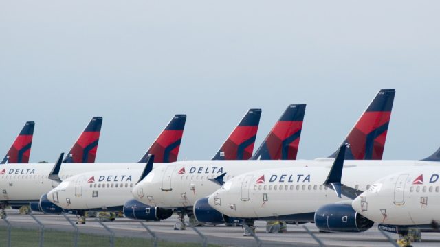 Delta Airplanes sit in a row at Kansas City International Airport