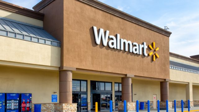 Walmart store exterior. Walmart is an American multinational corporation that runs large discount stores and is the world's largest public corporation.