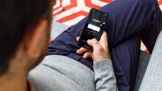Man using the new Apple iPhone Xs with the immense OLED retina display and a12 bionic chip, looking over the app application Amazon Prime video