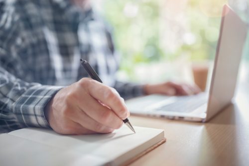 guy writing on paper