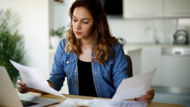 Serious young woman working at home