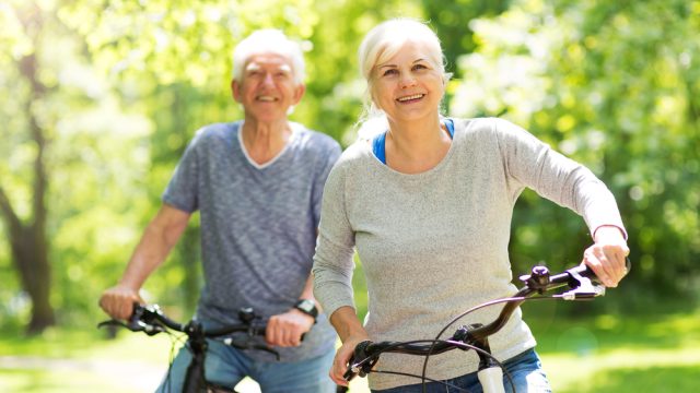 A senior couple riding bikes together