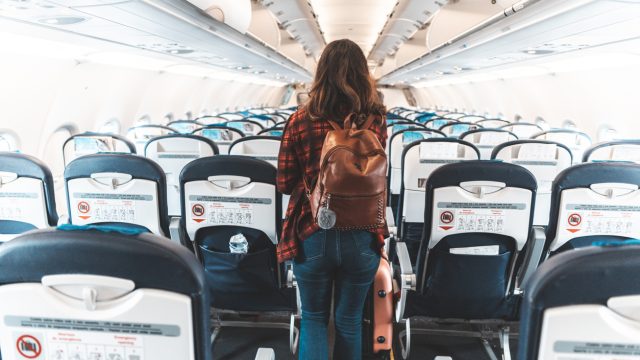 A woman boarding a commercial plane.
