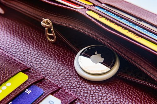 Apple AirTag in a wallet with discount cards and credit cards. New gadgets from Apple