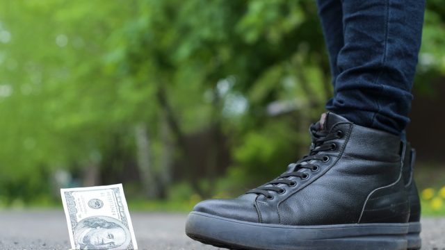 girl finding dollar in street
