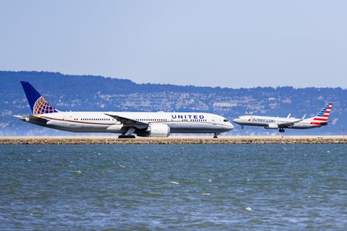 United Airlines aircraft preparing to take off and American Airlines aircraft landing at San Francisco International Airport (SFO)
