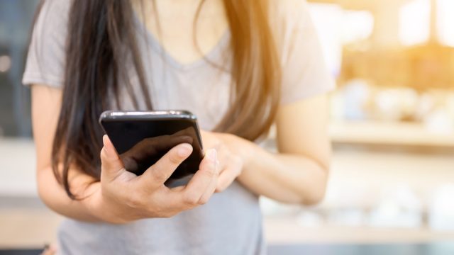 Close up image hand of woman using her mobile smartphone