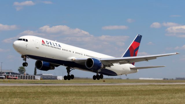 A Delta plane landing at an airport