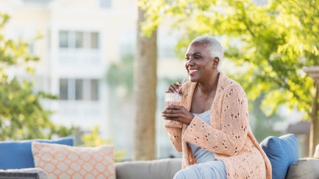older woman drinking straw