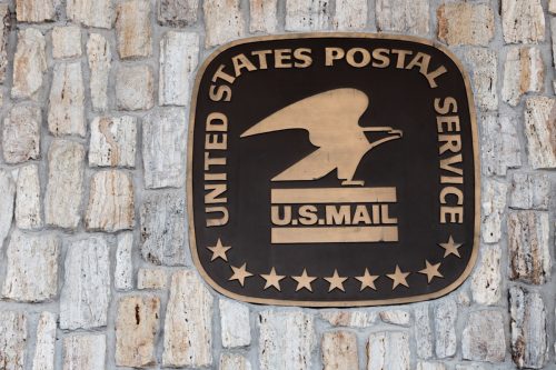 usps sign and logo on a wall