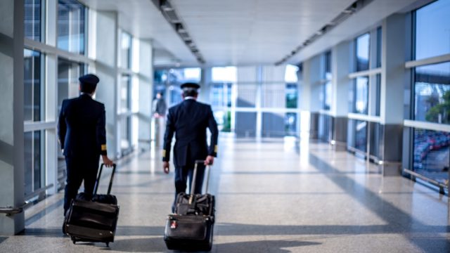 pilots walking through terminal