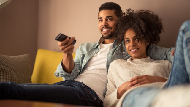 man and woman watching TV