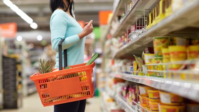 woman looking at grocery store shelves