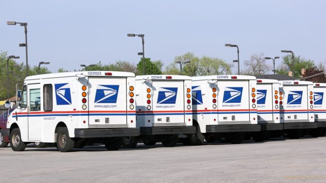 United States Postal Service mail delivery vehicles await deployment in Franklin Park, Illinois.