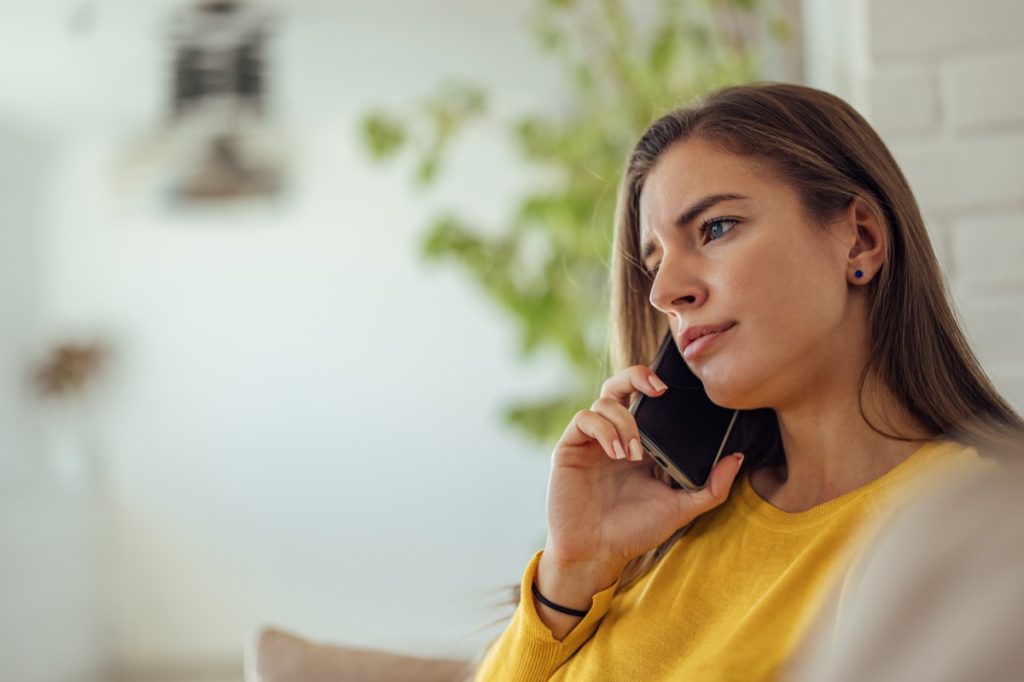Woman holding her phone to her ear