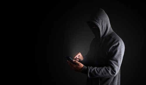 scammer using a smartphone