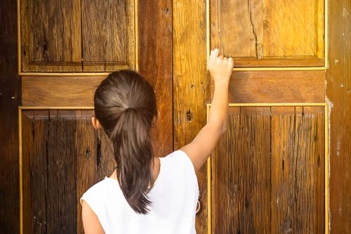 young girl knocking on door