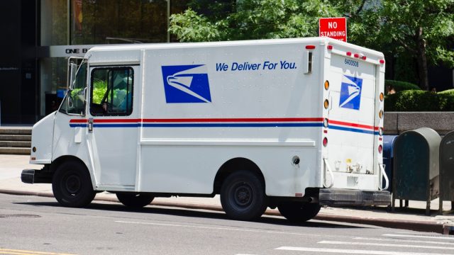 USPS van parked along the Fifth Avenue in New York City. USPS (the United States Postal Service)