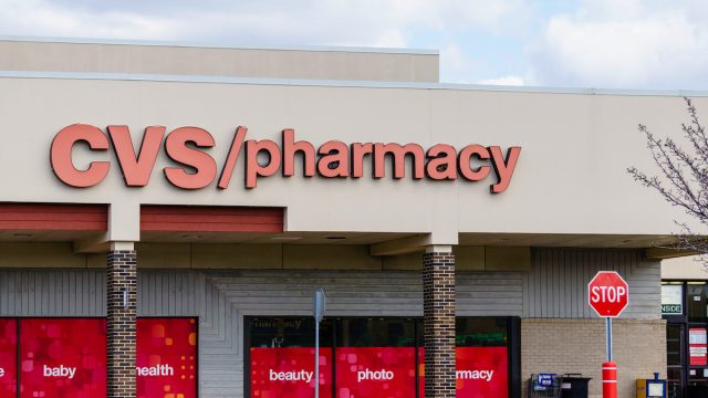 CVS Pharmacy storefront with a stop sign in front