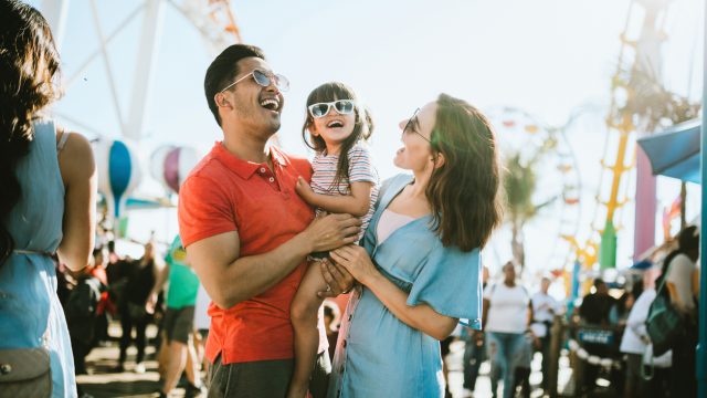 A family with their young child at an amusement park