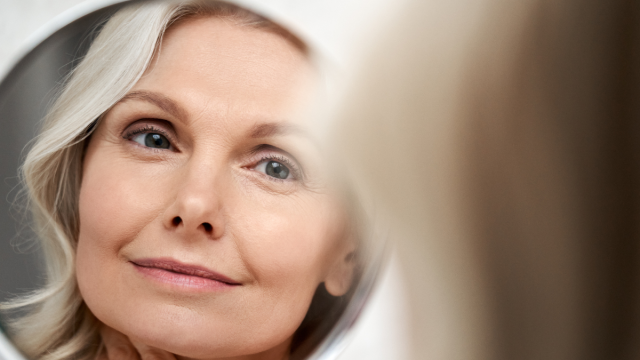 Older woman looking in mirror