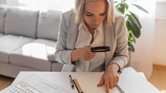 woman using a magnifying glass