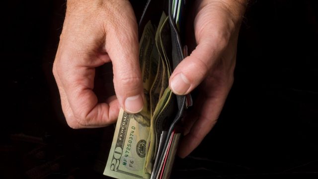 opening wallet twenty dollar bills