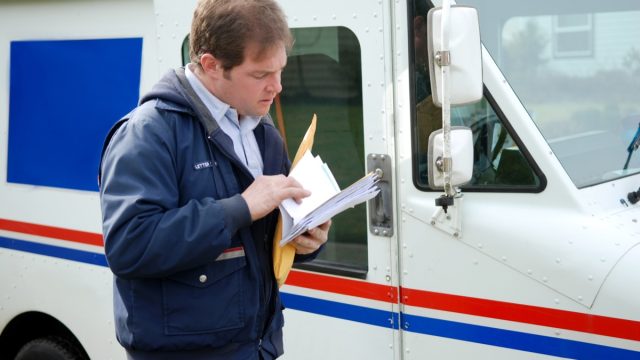 Mail Carrier Sorting the mail