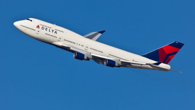 A Delta Air Lines plane in the air after taking off