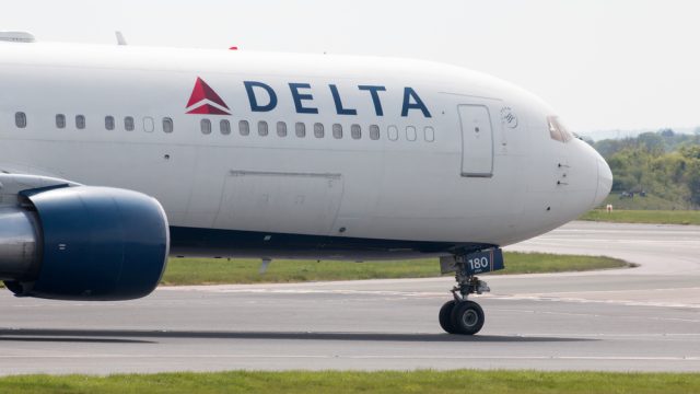 A Delta Air Lines jet taxiing on the runway at an airport