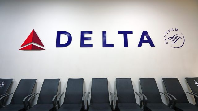 A Delta sign above seats in an airport terminal