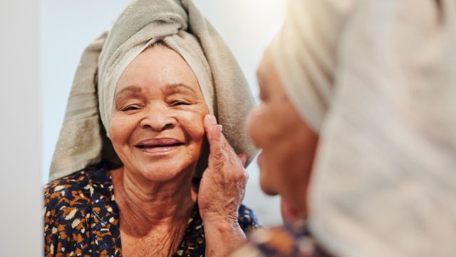 Shot of a mature woman applying her skincare in the bathroom