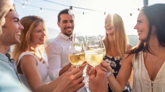 A group of friends drinking wine outdoors
