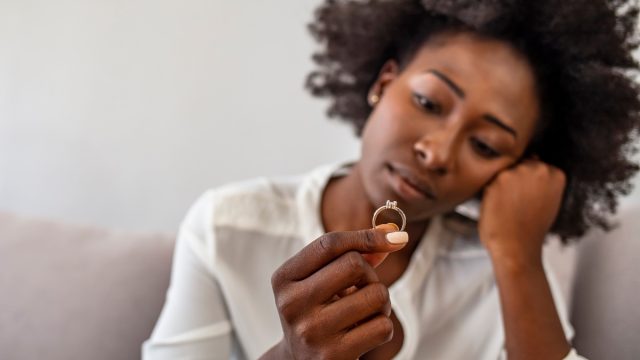 woman contemplating engaging ring