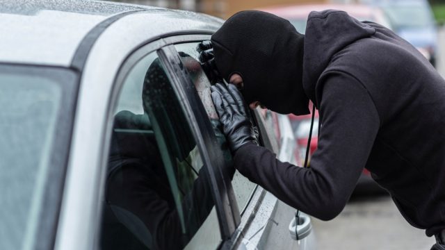 car thief looking in window