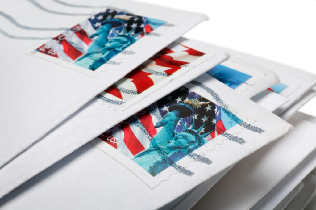 Close up on postage on stack of letters
