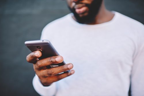 man dialing on smartphone